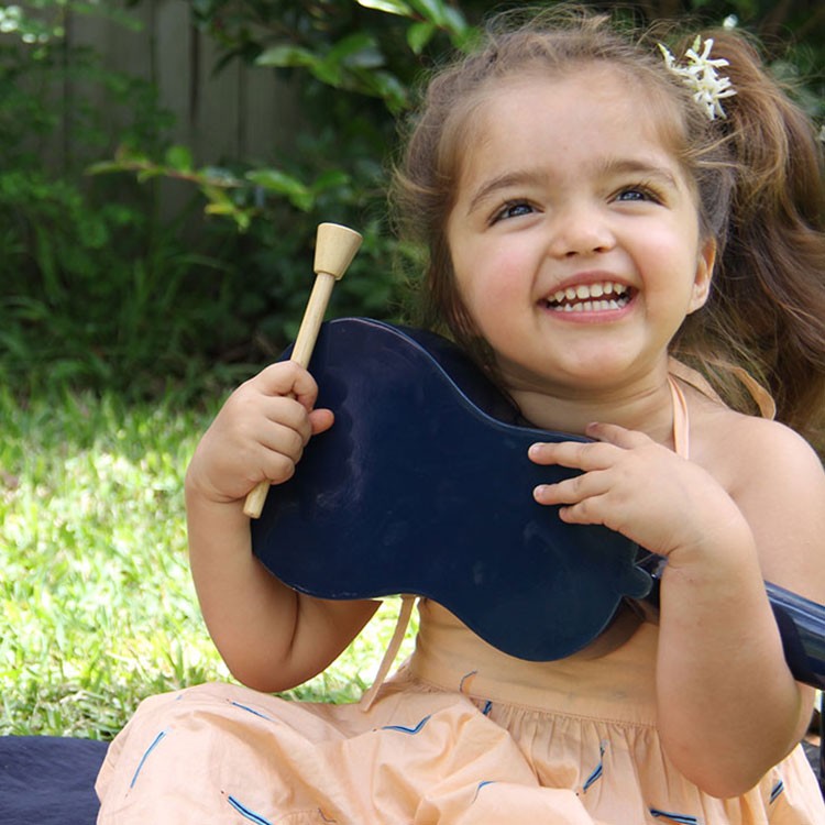 Toddler sharing musical instrument